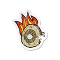 A creative retro distressed sticker of a cartoon burning shield