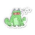 A creative retro distressed sticker of a cartoon burping frog