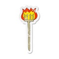 A creative retro distressed sticker of a cartoon flaming devil fork Royalty Free Stock Photo