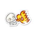retro distressed sticker of a cartoon flaming skull Royalty Free Stock Photo