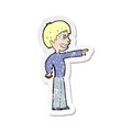 A creative retro distressed sticker of a cartoon grinning boy pointing Royalty Free Stock Photo