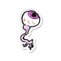 A creative retro distressed sticker of a cartoon gross eyeball