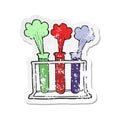 A creative retro distressed sticker of a cartoon rack of test tubes exploding Royalty Free Stock Photo