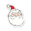 A creative retro distressed sticker of a cartoon santa claus face Royalty Free Stock Photo