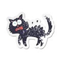 A creative retro distressed sticker of a cartoon scared black cat Royalty Free Stock Photo