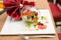 Creative salad serving in a restaurant, overturned glass wine glass with vegetables Royalty Free Stock Photo