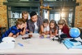 Creative school children with young asian teacher study an electronic constructor with fan and turn on flashlight Royalty Free Stock Photo