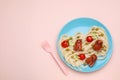 Creative serving for kids. Plate with cute octopuses made of sausages, pasta and vegetables on pink table, flat lay. Space for Royalty Free Stock Photo