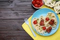 Creative serving for kids. Plate with cute octopuses made of sausages, pasta and vegetables on wooden table, flat lay. Space for Royalty Free Stock Photo
