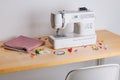 Creative Sewing Workspace Featuring a Modern Sewing Machine, Colorful Accessories, and a Neatly Folded Fabric Ready for Craft Royalty Free Stock Photo