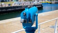 Creative shot of aesthetically pleasing, blue, coin operated lookout scope. Standing outside of the Waterfront.