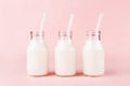 Three bottles of milk of yogurt on pink background Royalty Free Stock Photo