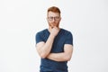 Creative and smart businessman thinking about new concept for business. Portrait of handsome strategist with red hair