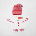 Creative snowman shape made of different items on white background, flat lay