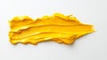 In a creative space, a studio image captures a close-up of an artistic yellow paint stroke on a white surface Royalty Free Stock Photo