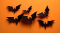 spooky black Halloween bats on orange background