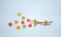 Creative spring concept of candy and trumpet with pastel blue background. Music creative concept composition with copy space.