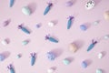 Creative Spring Easter concept on pastel purple background. Painted eggs and carrots for pink note or invitation. Flat lay Royalty Free Stock Photo