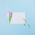 Creative spring flat lay with pink hearts, coffee cup, rosebuds and tulips on blue background. Minimal concept