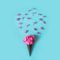 Creative still life. Bouquet of purple lilac flower in ice cream cone on pale pink background. Spring concept. Top view Royalty Free Stock Photo