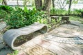 Creative stone bench under the tree in the park Royalty Free Stock Photo