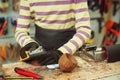 Creative student doing his project in workshop. Boy in the workshop makes crafts with coconut. School, development and learning Royalty Free Stock Photo