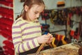 Creative student doing his project in workshop. Boy in the workshop makes crafts with coconut. School, development and learning Royalty Free Stock Photo