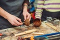 Creative student doing his project in workshop. Boy in the workshop makes crafts with coconut. School, development and learning Royalty Free Stock Photo