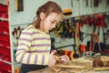 Creative student doing his project in workshop. Boy in the workshop makes crafts with coconut. School, development and learning Royalty Free Stock Photo