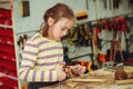 Creative student doing his project in workshop. Boy in the workshop makes crafts with coconut. School, development and learning Royalty Free Stock Photo