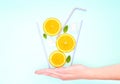 Creative summer cocktail concept. Glass of lemonade made of straws, orange slices, fresh mint leaves and ice cubes Royalty Free Stock Photo
