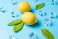 Creative summer composition with lemon and ice cubes on blue background. Minimal drink concept Royalty Free Stock Photo