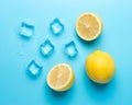 Creative summer composition with sliced lemon and ice cubes on blue background. Minimal drink concept Royalty Free Stock Photo