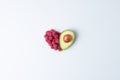 Creative summer concept. Heart shape made from fresh berries and avocado on grey background. Flat lay, copy space Royalty Free Stock Photo