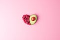 Creative summer concept. Heart shape made from fresh berries and avocado on pink background. Flat lay, copy space Royalty Free Stock Photo