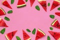 Creative summer food concept. Watermelon pattern. Juicy slices of ripe red watermelon and mint leaves on pink background. Flat lay