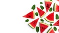 Creative summer food concept. Watermelon pattern. Juicy slices of ripe red watermelon and mint leaves on white background. Flat Royalty Free Stock Photo