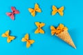 Creative summer layout made of ice cream cone, waffle cones and colored pasta semolina