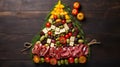 Creative table setting for the holiday, a Christmas tree made of food. Cheese sausage and various vegetables. Wooden