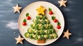 Creative table setting for the holiday, a Christmas tree made of food. Cucumbers, broccoli and Tomatoes on a plate. Blue Royalty Free Stock Photo