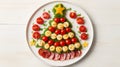 Creative table setting for the holiday, a Christmas tree made of food. Sausage with Tomatoes, eggs, cheese and fresh Royalty Free Stock Photo