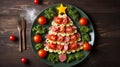 Creative table setting for the holiday, a Christmas tree made of food. Sausage with Tomatoes, fresh greens on a plate