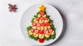 Creative table setting for the holiday, a Christmas tree made of food. Sausage with Tomatoes, fresh greens on a plate Royalty Free Stock Photo