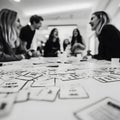 Creative Team Brainstorming Session with Laughter and Idea Cards on a Modern Workspace Table Royalty Free Stock Photo