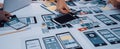 Creative Team Collaborating on Mobile App Design Prototype with Various Wireframes and Layouts for User Interface Royalty Free Stock Photo