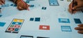 Creative Team Collaboration on Modern App Design and Wireframe Development with Sketches and Prototypes on Table SACTR Royalty Free Stock Photo