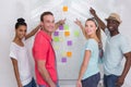 Creative team pointing at sticky notes Royalty Free Stock Photo