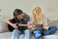 Creative teenagers friends with musical instruments, acoustic guitar and ukulele Royalty Free Stock Photo