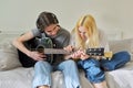 Creative teenagers friends with musical instruments, acoustic guitar and ukulele Royalty Free Stock Photo
