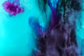 creative texture with turquoise and purple swirls of paint in water